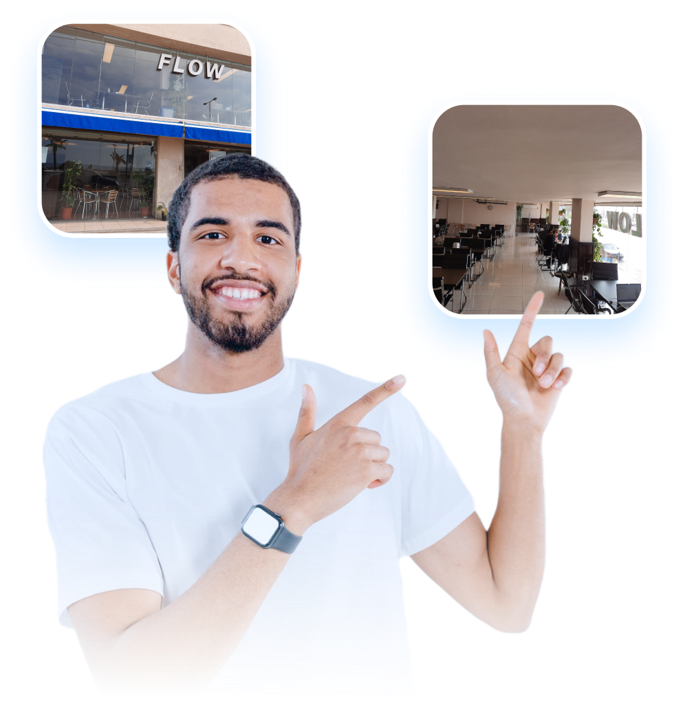 A man pointing towards pictures of the startup support center